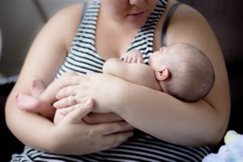 Mother cradling infant